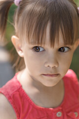 portrait of an emotional 3-year-old girl with black expressive eyes