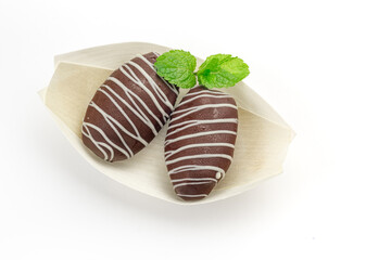 Chocolate covered dates sweet arab candies for dessert isolated on white, top view