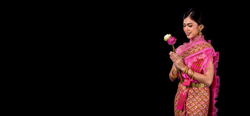 Loykratong tradition,Beautiful women dressed in Thai national costumes. hold kratong isolated on black background, Studio shot