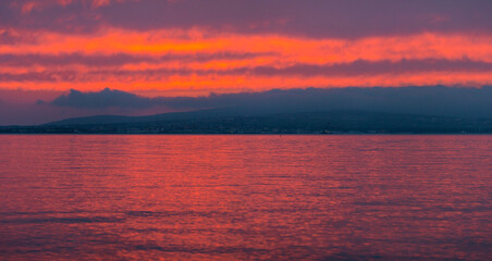 Seascape. Sun in the clouds at sunset over the sea