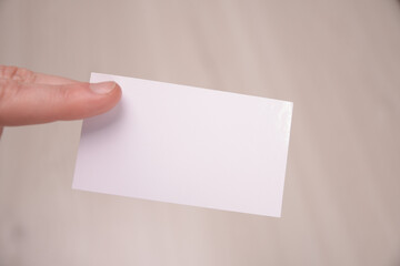 Hand hold blank white card mockup with rounded corners. Plain call-card mock up template holding arm. Plastic credit namecard display front. Check offset card design. Business branding.