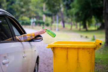 Woman hand picking up garbage plastic and Glass bottles for cleaning at park