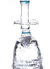 Overflowing water in a clear bottle Fill the bottle with water until the water spreads. White background