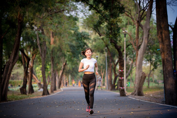 Asian woman is warm up, To make the muscles flexible Before going to jogging for good health and energy metabolism,Outdoors cross training workout. Healthcare concept