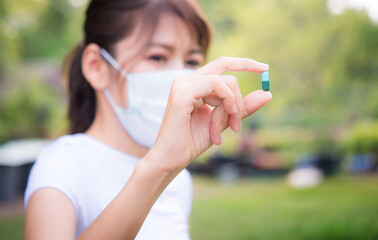 Close up of woman putting pill in mouth. Sick female taking medicines, antidepressant, painkiller...
