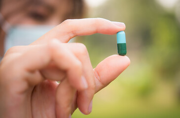 Close up of woman putting pill in mouth. Sick female taking medicines, antidepressant, painkiller...