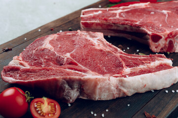 Raw beef meat fillet on wooden board