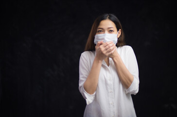Portrait of an Asian woman putting on a sanitary face and locking herself in the room because of being ill from being infected with the Covid virus 19 and being stressed