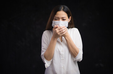 Portrait of an Asian woman putting on a sanitary face and locking herself in the room because of being ill from being infected with the Covid virus 19 and being stressed