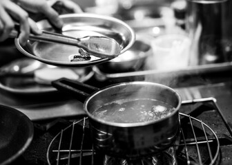Chef cooking in a kitchen, chef at work, Black and White.