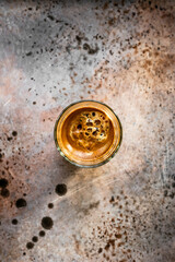 A glass of black coffee with froth or crema, top view