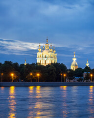 Naklejka premium Russia, St. Petersburg - July 19, 2020: View of the Smolny Cathedral from the Neva at night on a cloudy summer day. Russia, Saint-Petersburg