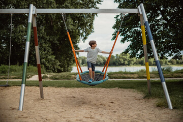 standing on net swing and having fun  on playground