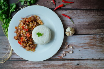 Fried pork with spices such as chili, garlic, salt. Thai food with jasmine rice.