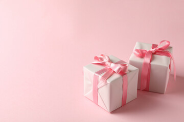 Gift boxes on pink background, space for text