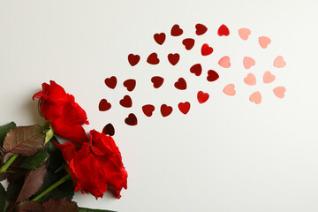 Red roses and glitter hearts on white background