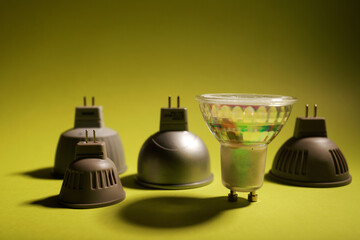 several dichroic LED bulbs on a plain yellow background