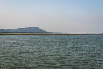 river island with mountain backdrop at dusk