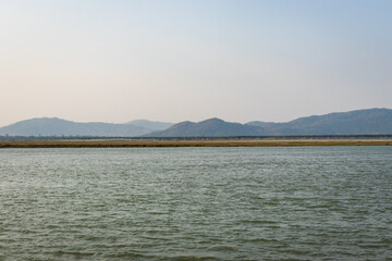 river island with mountain backdrop at dusk