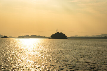 sunset orange sky with river island backdrop at dusk