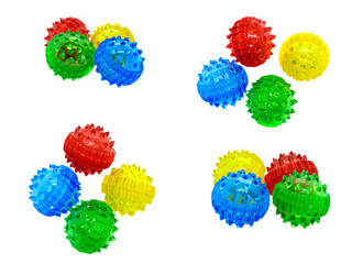 A set of groups of su jok massage balls from different sides isolated on a white background. Piles of massagers in red, blue, yellow, and green.