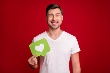 Photo of positive young man smile arm holding paper like paper look camera isolated on burgundy color background