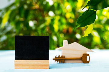 Wooden toy house and house keys close up