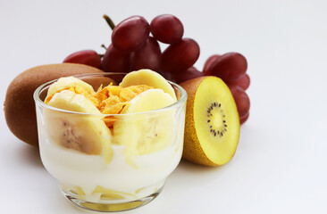 Mix fruits yogurt ,banana, kiwi, grape and conflake. Concept of healthy eating.