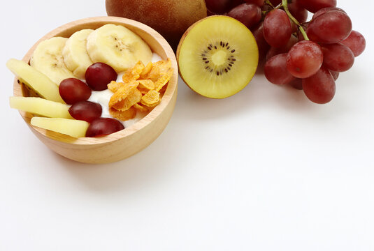 Mix fruits yogurt ,banana, kiwi, grape and conflake. Concept of healthy eating.