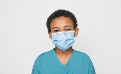 African American boy girl with a medical protective face mask during a global epidemic, isolated on...