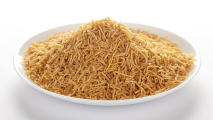 Indian spicy snacks (Namkeen) - Bikaneri Besan Bhujia in a white plate, made with chickpea flour (Besan), side view, against the white background.