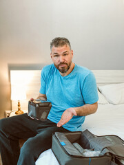 Unhappy shocked man with chronic breathing issues surprised by using  CPAP machine sitting on the...