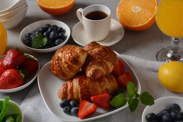 Tasty breakfast. Croissants, fresh and dried fruits, fresh juice