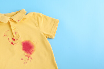 dirty stain on clothes. isolated on blue background. space for text