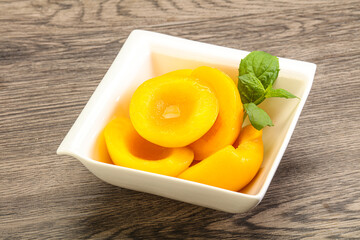 Sweet ripe canned peaches with mint