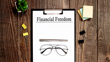 financial freedom text form on the wooden table.