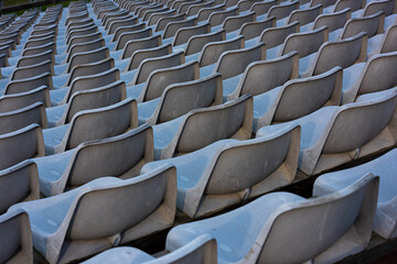 Empty grey  seats on a seating tribune.