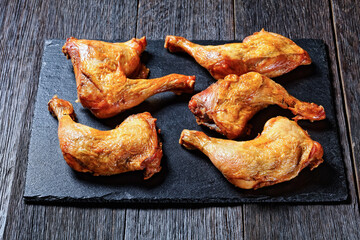 roast chicken legs on a stone tray, top view