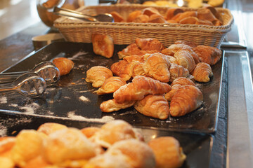 Sweet pastry pieces sprinkled with sugar displayed in dining hall of all inclusive hotel resort
