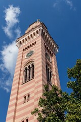 Obraz premium The restored high tower with a clock and a bell at the territory of The Church of Holy Transfiguration in Pancevo, Serbia