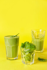 Glasses of healthy spinach smoothie on color background