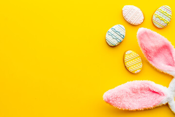 Happy Easter. Bunny ears with colorful eggs cookie, top view