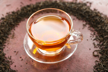 Cup of hot black tea on table