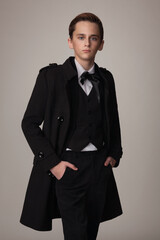 Obraz na płótnie Canvas teen boy in stylish black coat