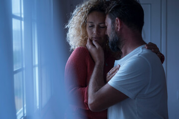 Couple and passion at home with young adult man and woman kissing and hugging in the evening light...