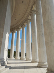 Sun shining through columns at the Jefferson Memorial in Washington DC