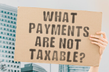 The phrase " Is Unemployment Taxable? " on a banner in men's hand with blurred background. Law. Taxes. Payment. Commission. Government. Power. Charge. Fees