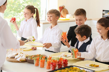 Pupils receiving lunch in school canteen