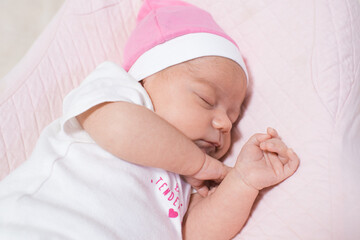 Cute, small and adorable newborn baby girl sleeping