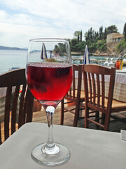 A glass of red wine is on the table